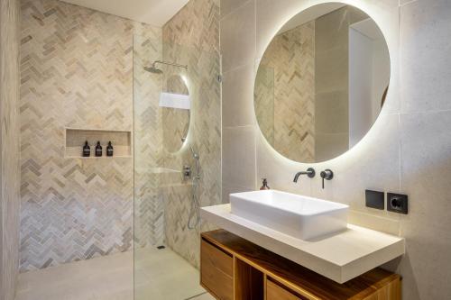 a bathroom with a sink and a shower at Ferreno Villa - Family-Friendly Designer Villa- Private Pool - Central in Kerobokan