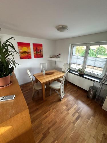 a dining room with a wooden table and chairs at Beautiful studio apartment in Nordhausen