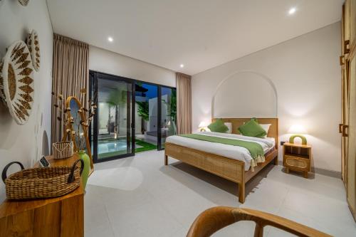 a bedroom with a bed and a balcony at Ferreno Villa - Family-Friendly Designer Villa- Private Pool - Central in Kerobokan