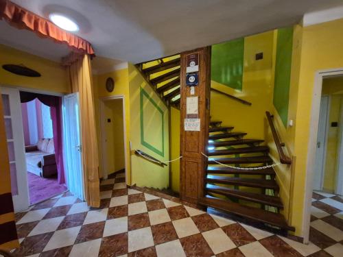 a hallway with a spiral staircase in a room at Tornácos ház in Mátraszentimre