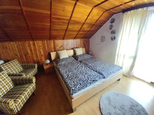 a bedroom with a bed and two couches in it at Apartmán Ivona in Dedinky