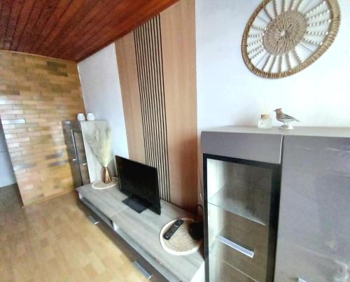 a living room with a fireplace with a laptop on it at Apartmán Ivona in Dedinky