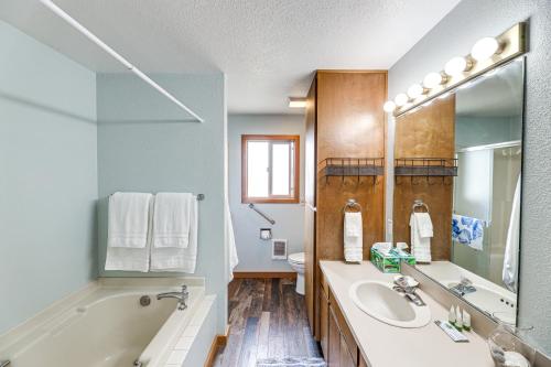 a bathroom with a tub and a sink and a mirror at Walk to Beach Dog-Friendly Home in Lincoln City in Lincoln City