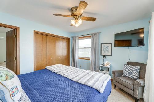 a bedroom with a blue bed and a ceiling fan at Walk to Beach Dog-Friendly Home in Lincoln City in Lincoln City