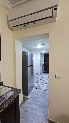 an empty kitchen with a stainless steel refrigerator at The Nest - Tiran View in Sharm El Sheikh