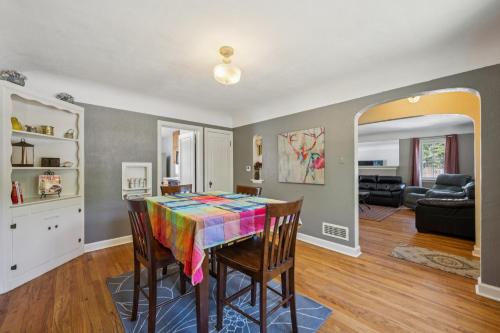 a dining room with a table with a colorful blanket on it at Charming Home Near UNC & DT Greeley home in Greeley