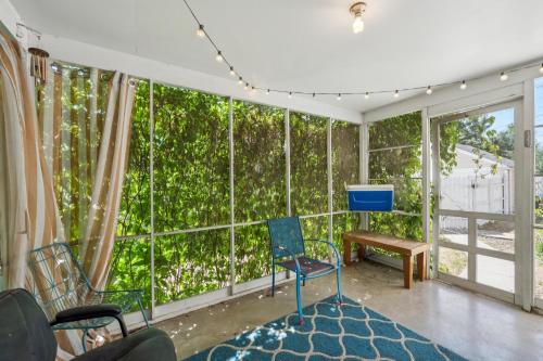 a room with a large window with chairs and a table at Charming Home Near UNC & DT Greeley home in Greeley