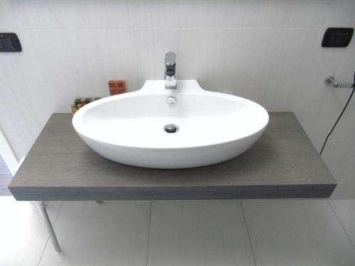 a white sink on a counter in a bathroom at Areté Luxury Room in Reggio Calabria