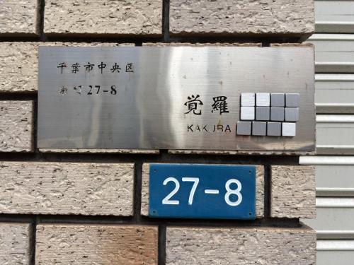 a sign on the side of a brick building at 覚羅中央区別荘101室 in Chiba