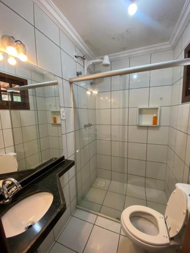 a bathroom with a shower and a toilet and a sink at Casa em Guaramiranga, ao meio da Natureza! in Guaramiranga