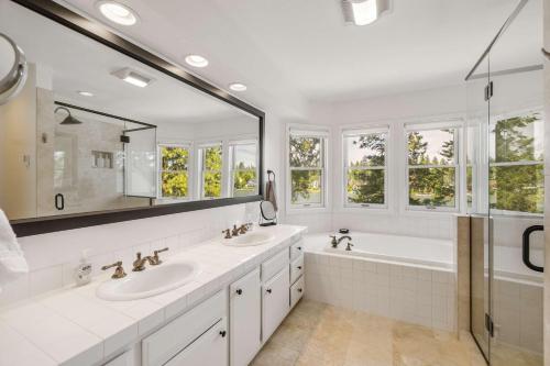 a bathroom with two sinks and a large mirror at Paradise Found in Coeur d'Alene
