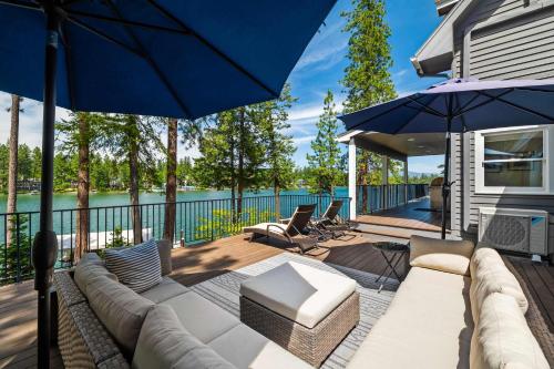 a patio with a couch and an umbrella at Paradise Found in Coeur d'Alene