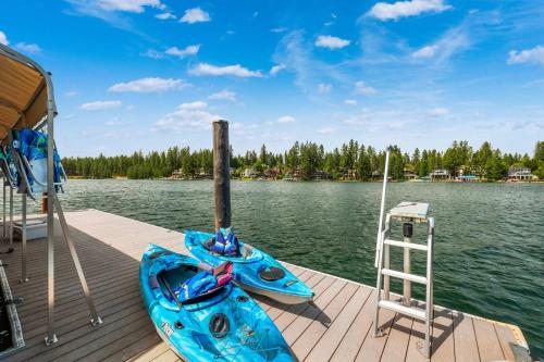a dock with two kayaks and a ladder on the water at Paradise Found in Coeur d'Alene