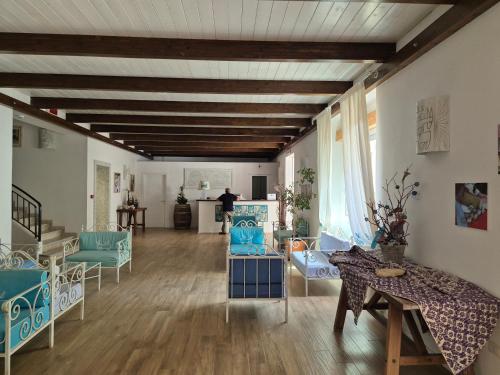 a living room with blue chairs and a table at Alghero Vacanze Hotel in Alghero