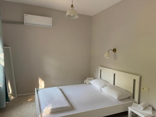 a white bedroom with a white bed in it at Sea Salt Inn , Kitchene in Kemer