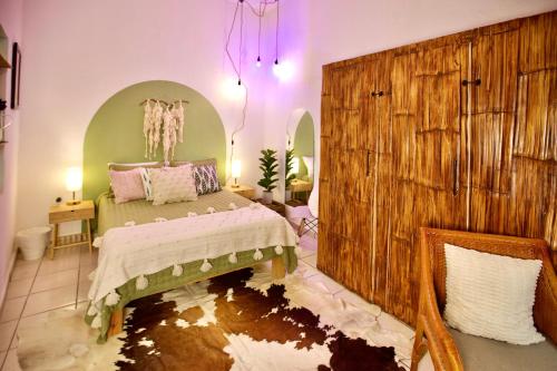 a bedroom with a bed in a room with a mirror at Studio Verdejo - Zona Romantica in Puerto Vallarta