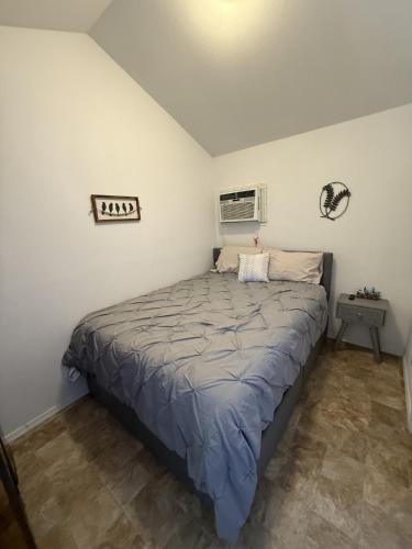 a bedroom with a large bed in a room at Rogue River Landing Resort in Gold Beach
