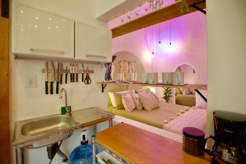 a small kitchen with a couch and a sink in a room at Studio Verdejo - Zona Romantica in Puerto Vallarta