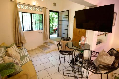 a living room with a couch and a table at Studio Verdejo - Zona Romantica in Puerto Vallarta