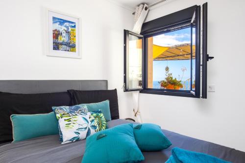 a living room with a couch and a window at Villa with Panoramic Sea View & Private Pool Roquebrune-Cap-Martin & Monaco in Roquebrune-Cap-Martin