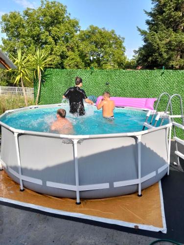 a group of three men in a hot tub at Nasa kuca in Gročanska Ada