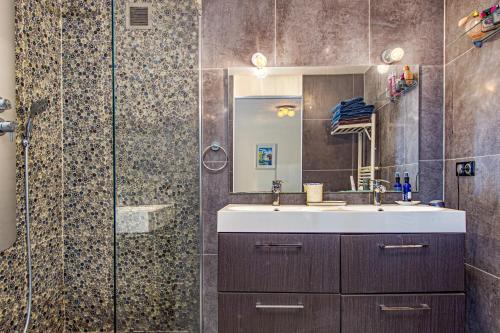 a bathroom with a sink and a shower at Villa with Panoramic Sea View & Private Pool Roquebrune-Cap-Martin & Monaco in Roquebrune-Cap-Martin