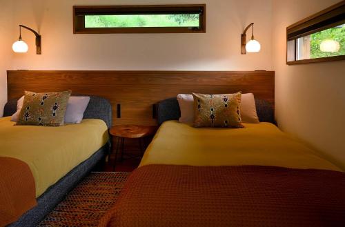 a bedroom with two beds and a window at Nantan - House - Vacation STAY 82583v in Ōno