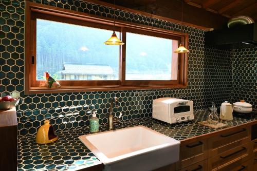 a kitchen counter with a sink and a window at Nantan - House - Vacation STAY 82583v in Ōno
