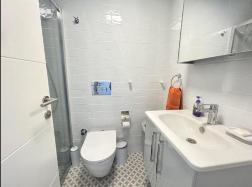 a small bathroom with a toilet and a sink at Vista Marina Çeşme in Çeşme
