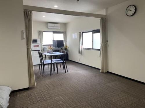 a room with a kitchen and a table and chairs at Guest House Shine Bright - Vacation STAY 19291 in Fukuoka