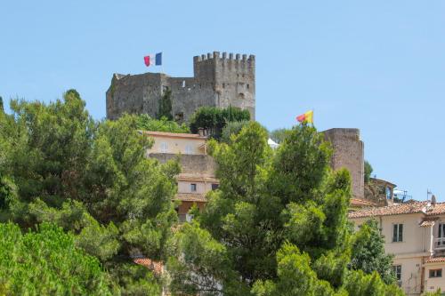 a castle on top of a hill with trees at Villa with Panoramic Sea View & Private Pool Roquebrune-Cap-Martin & Monaco in Roquebrune-Cap-Martin