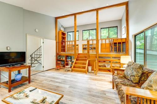 a living room with a couch and a tv at Walk to Semi-Private Beach Lake Michigan Getaway in Montague