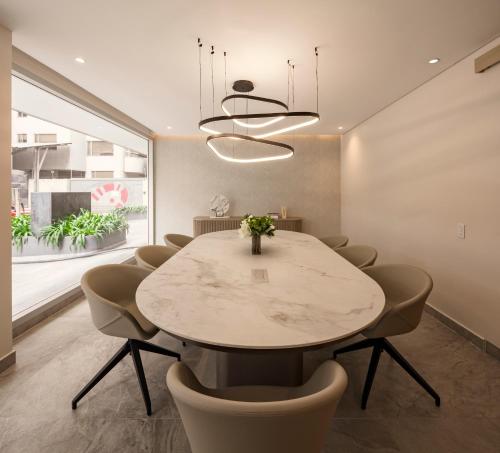 a dining room with a marble table and chairs at Le Parc Hotel, Beyond Stars in Quito
