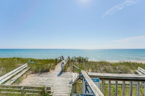 a boardwalk to the beach with the ocean in the background at Walk to Semi-Private Beach Lake Michigan Getaway in Montague