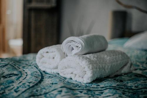 two towels sitting on top of a bed at Pousada da Janjana in Nova Iguaçu