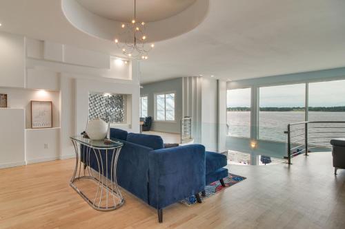a living room with a blue couch and a table at Indoor Pool and Waterfront Deck Spacious Jay Home in Jay