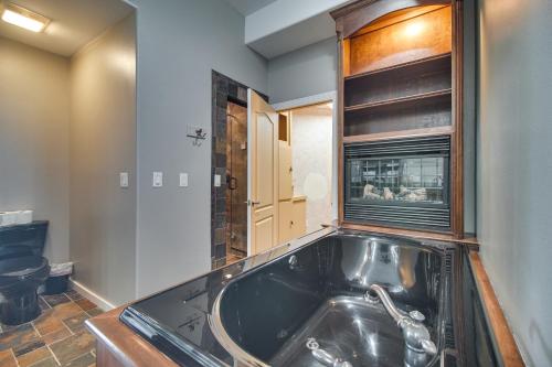 a bathroom with a large black bath tub at Indoor Pool and Waterfront Deck Spacious Jay Home in Jay
