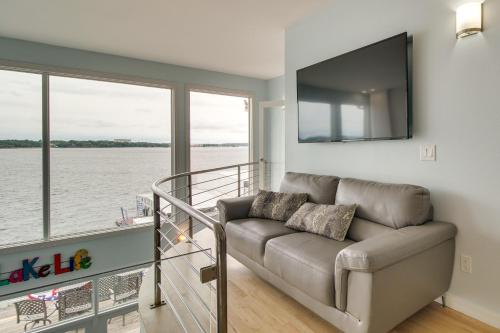 a living room with a couch and a large window at Indoor Pool and Waterfront Deck Spacious Jay Home in Jay