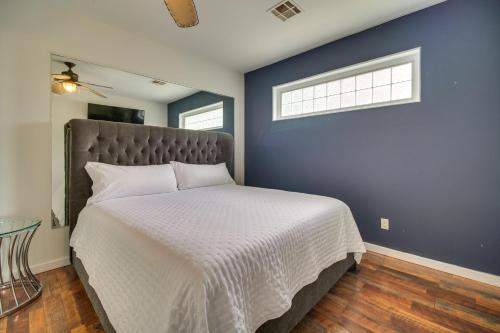 a bedroom with a large bed with a blue wall at Indoor Pool and Waterfront Deck Spacious Jay Home in Jay