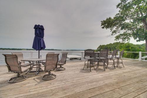 a table and chairs and an umbrella on a deck at Indoor Pool and Waterfront Deck Spacious Jay Home in Jay