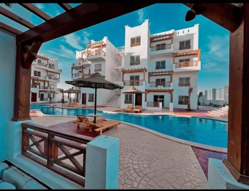 a hotel with a swimming pool and some buildings at The Nest - Tiran View in Sharm El Sheikh