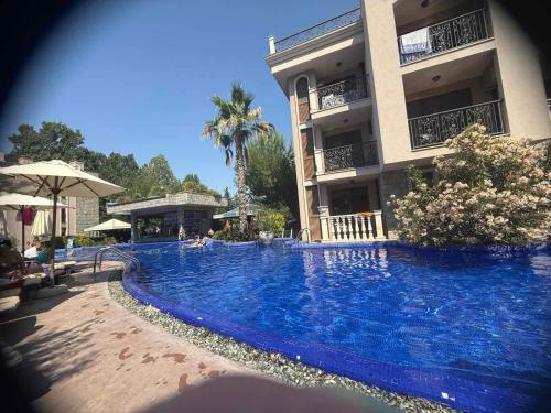 a large blue swimming pool next to a building at Flat in Cascadas 21 in Sunny Beach