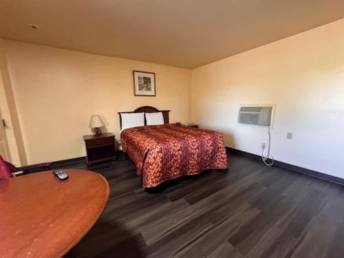 a hotel room with a bed and a table at Whispering Pines by Hotel O White stone VA in White Stone