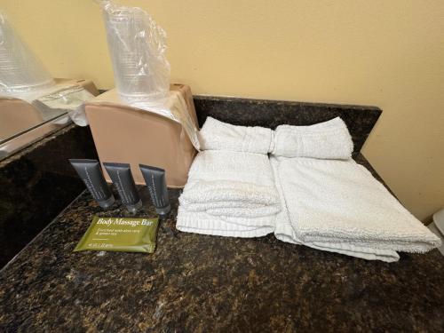 a counter with two towels and a box on it at Whispering Pines by Hotel O White stone VA in White Stone