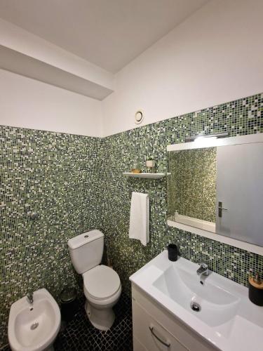 a bathroom with a toilet and a sink and a mirror at Sea view Cascais in Cascais