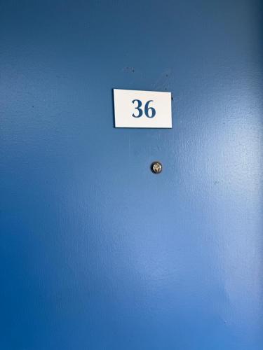 a sign on a wall with the number on it at Whispering Pines by Hotel O White stone VA in White Stone