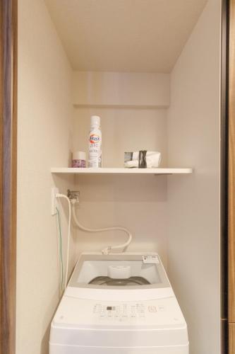 a washing machine in a bathroom with a shelf at LANG HOTEL Kameido - Vacation STAY 79517v in Tokyo