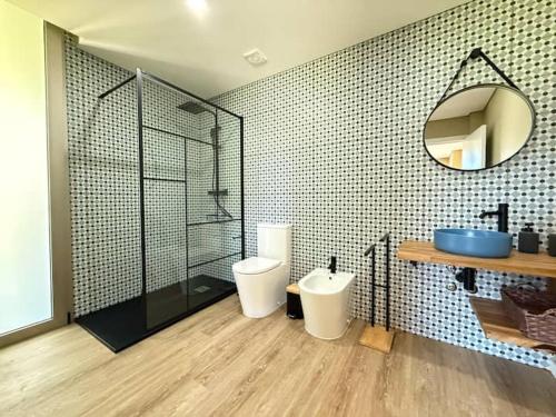 a bathroom with a shower and a toilet and a sink at Perral Nature - Casa do Carvalho - Gerês in Terras de Bouro