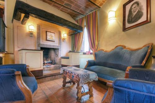 a living room with a couch and a fireplace at Country House Federico I in Sassoferrato