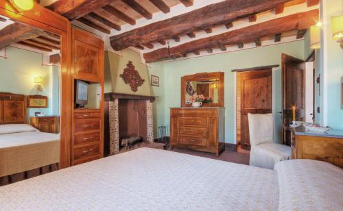 a bedroom with two beds and a fireplace at Country House Federico I in Sassoferrato